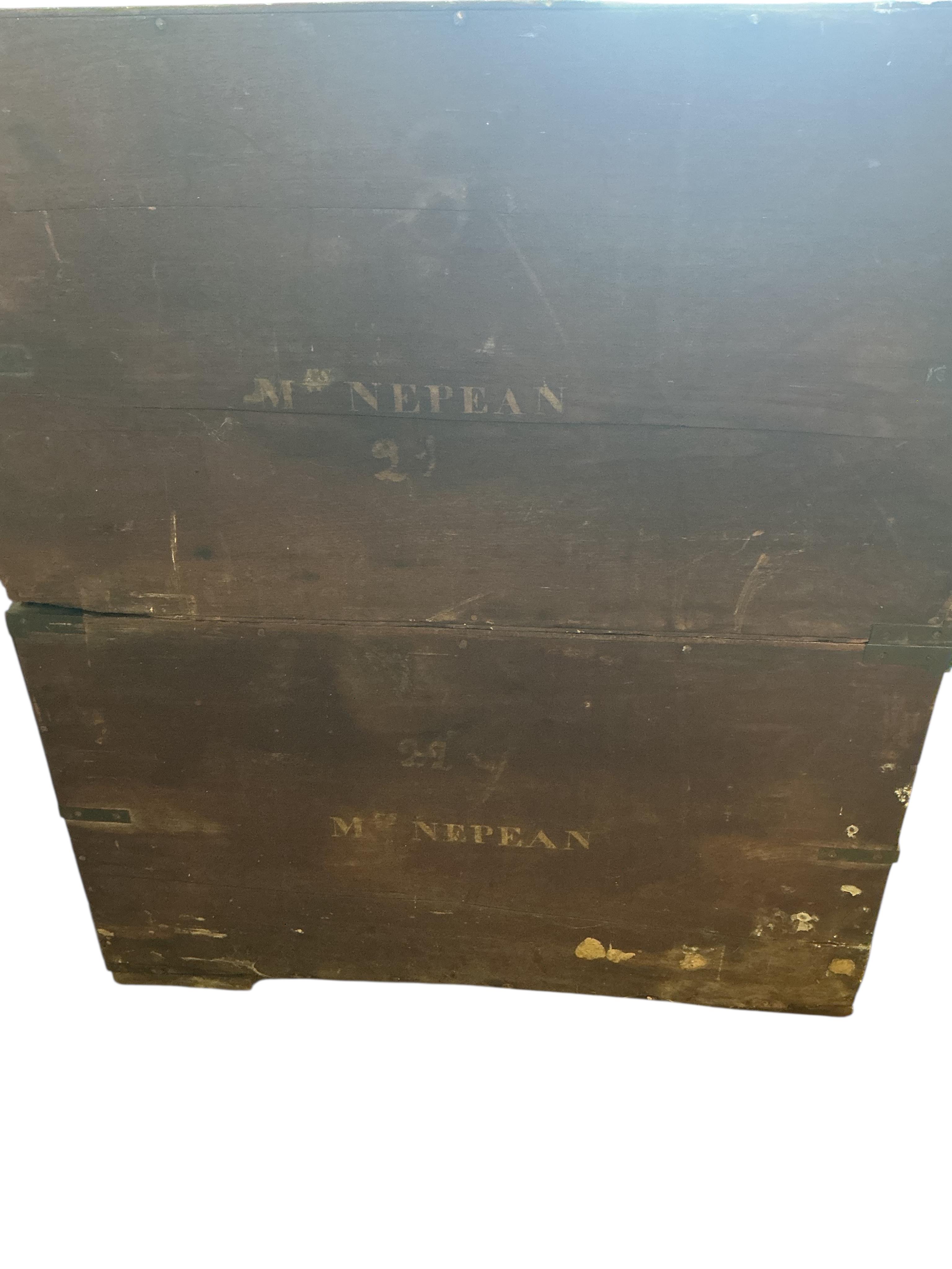 A small early 19th century teak two part campaign chest, the back with stencilled name, Mrs Nepean, width 81cm, depth 46cm, height 95cm